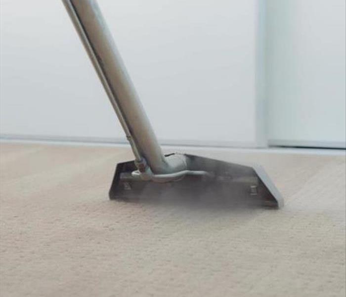 Vacuum extracting water from a carpet